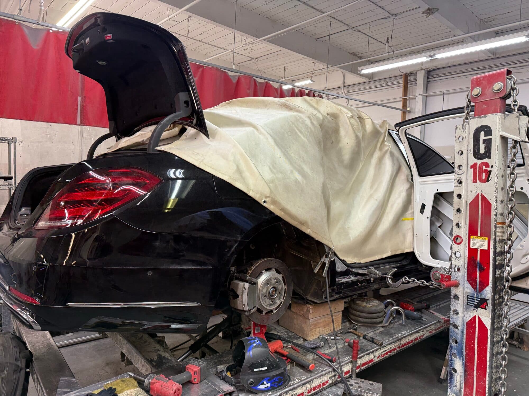 A Mercedes on the frame rack at Alpina Auto Body, Southeast Portland