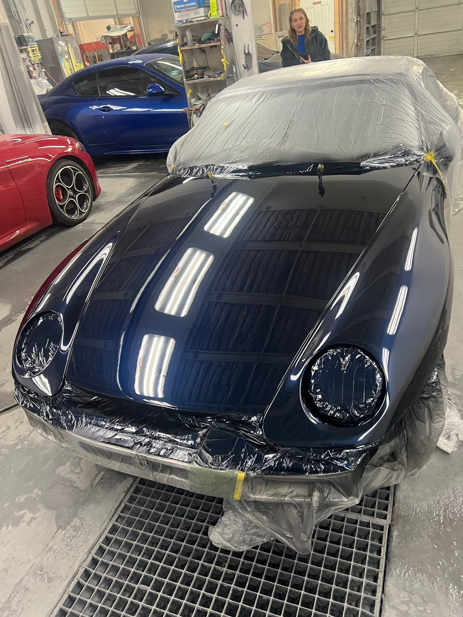 A dark Porsche masked for a custom paint job at Alpina Auto Body, Southeast Portland