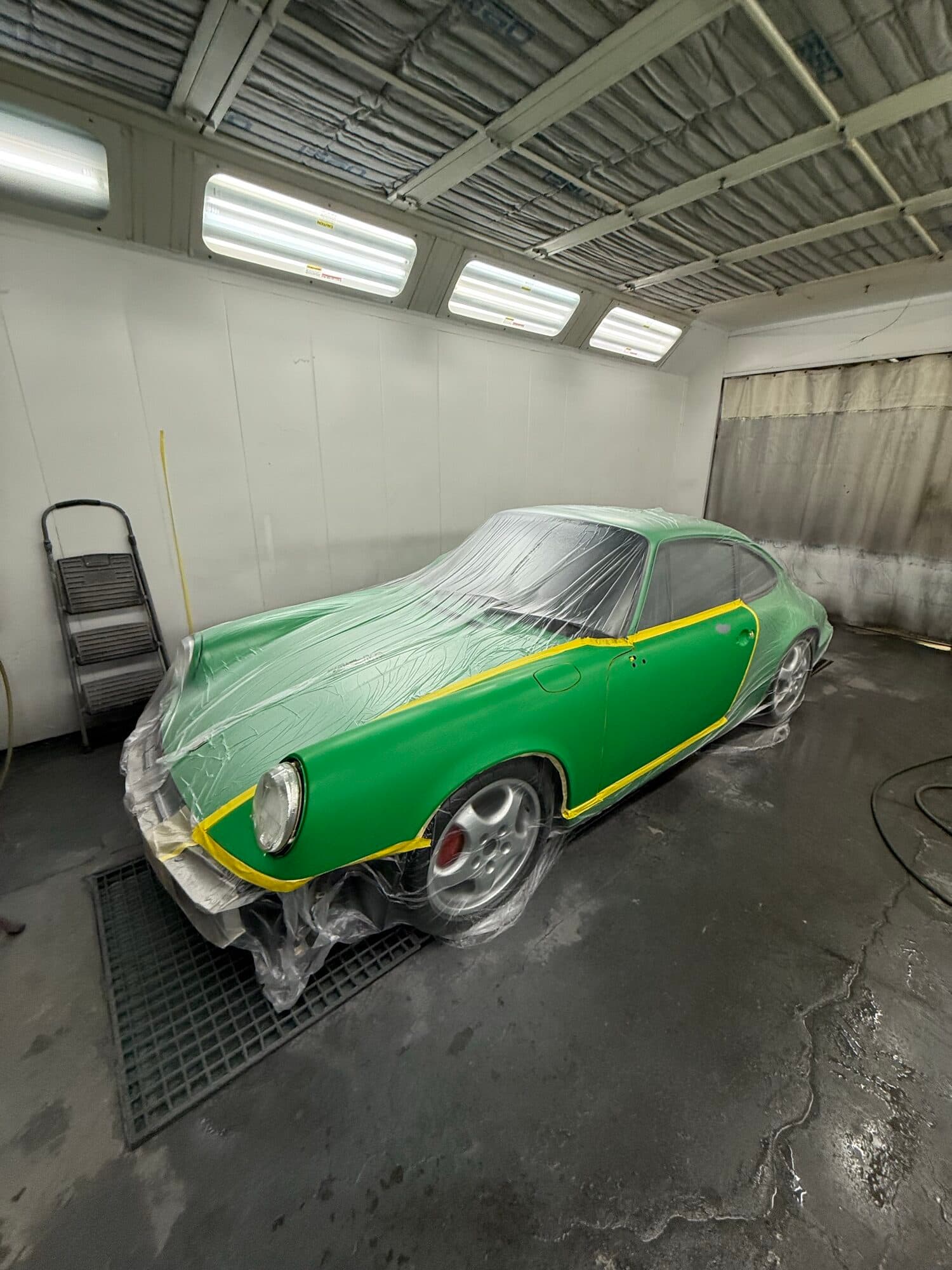 Classic air-cooled Porsche 911 in green, in the heated paint booth at Alpina Auto Body in Southeast Portland